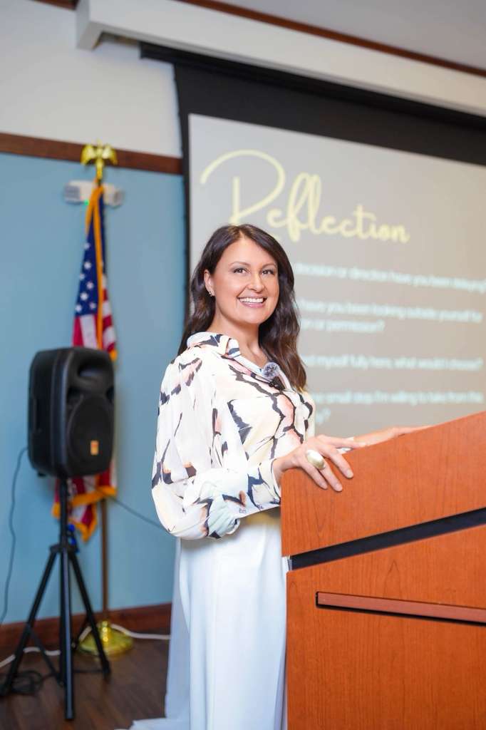 A presenter addresses the community from the podium.