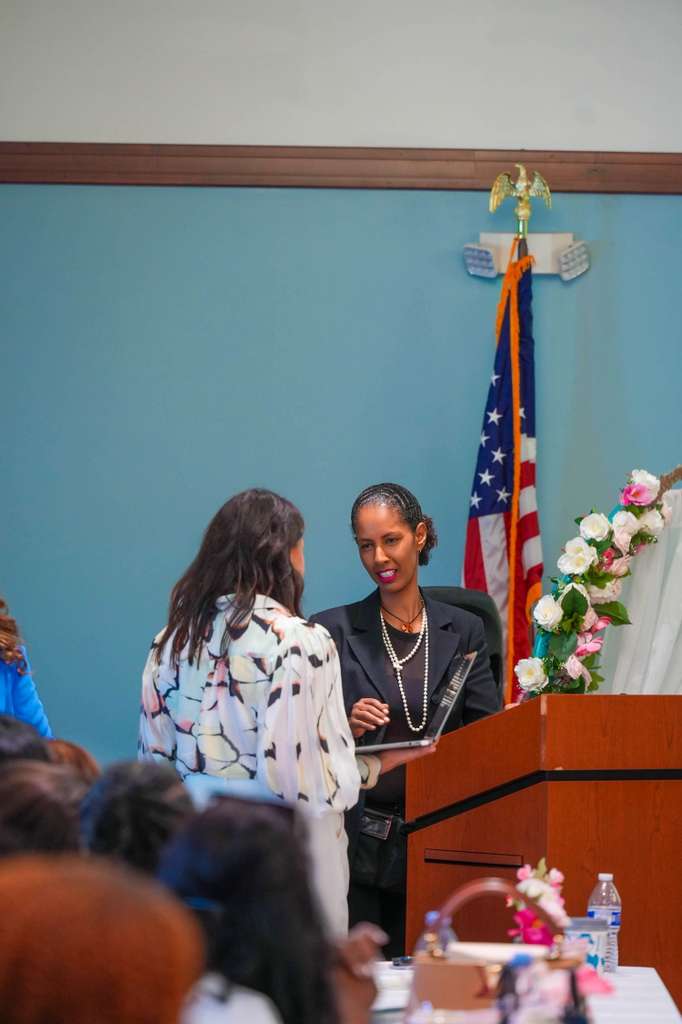 A community member receives recognition during the program.